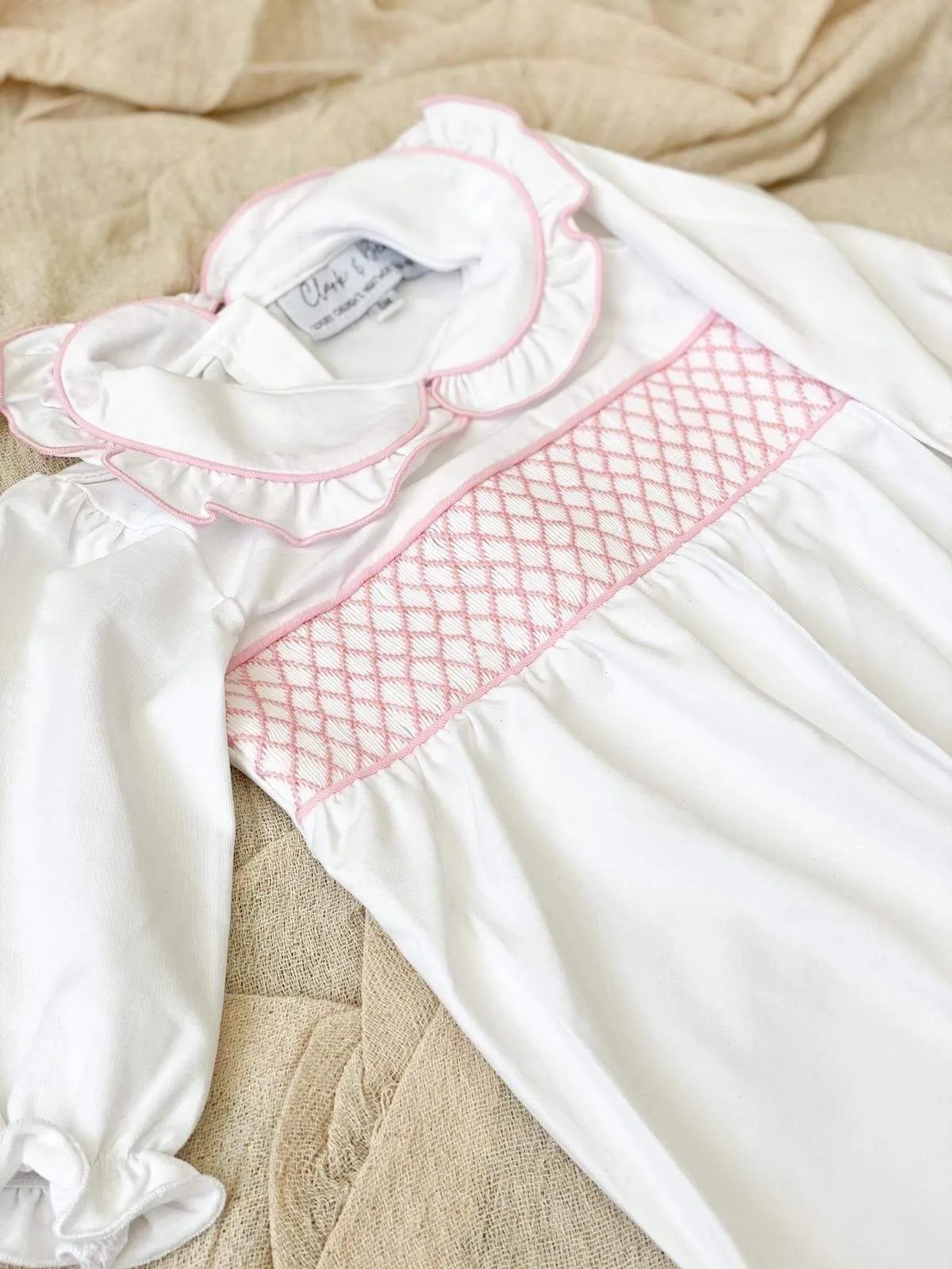 Girls smocked baby grow - white trimmed with pink